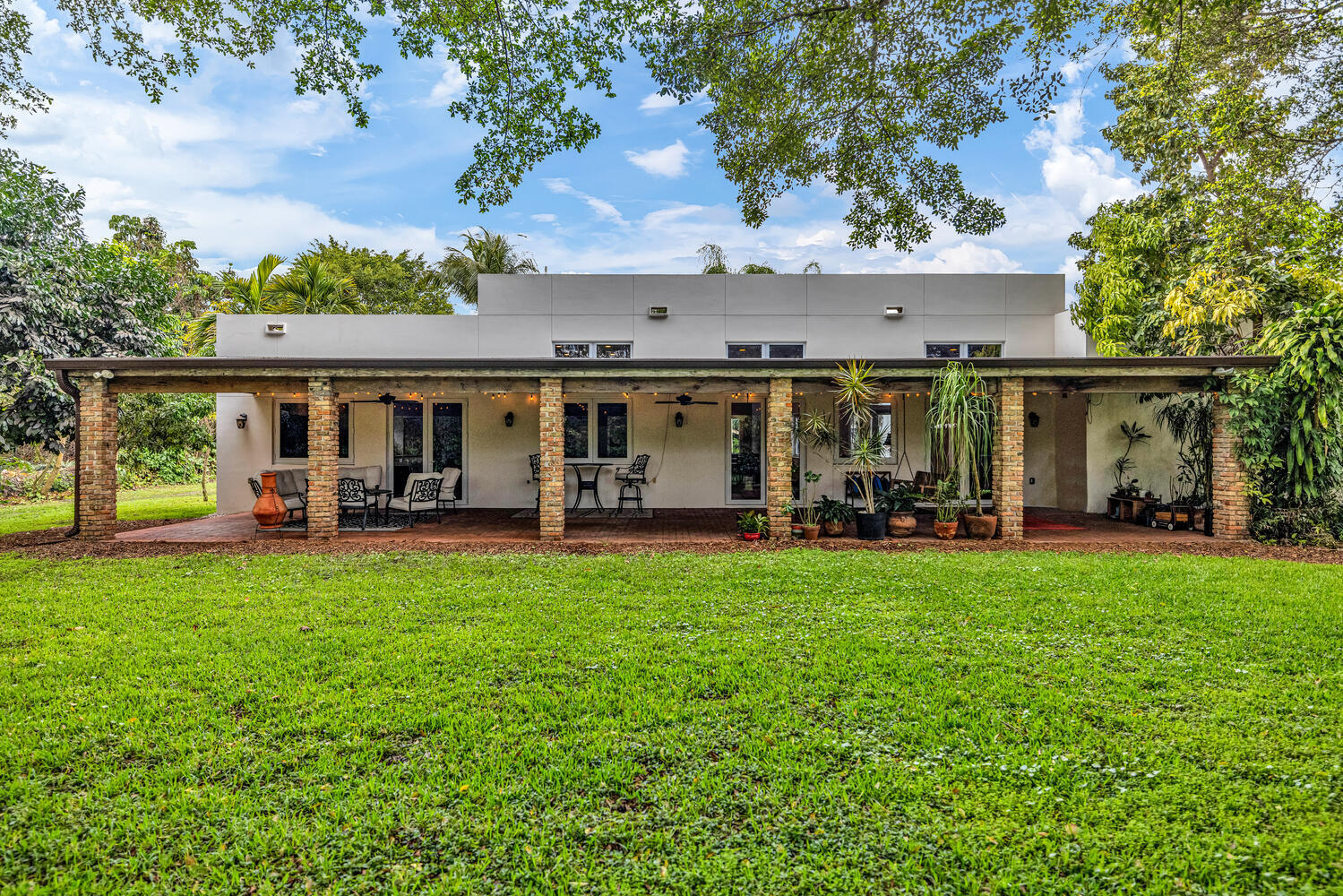 12301 Southwest 107th Avenue Miami, FL 33176 - Photo 6 of 58 front view of a house with a patio yard and balcony