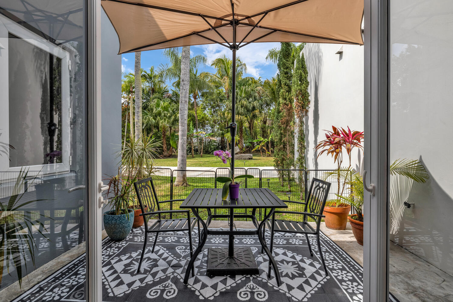 12301 Southwest 107th Avenue Miami, FL 33176 - Photo 10 of 58 a patio with glass top table and chairs