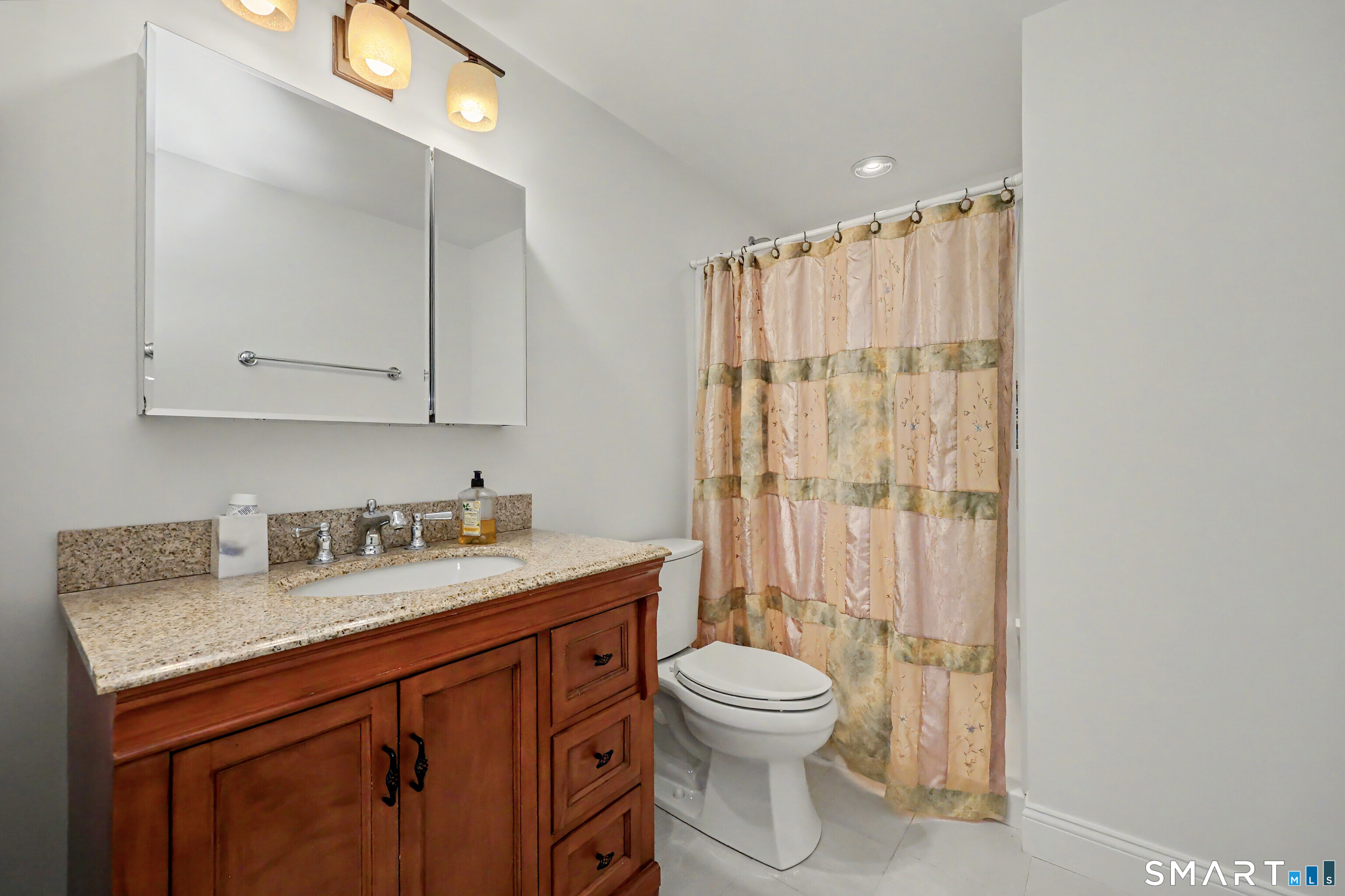 70 Fawn Ridge Lane, Unit 70 Norwalk, CT 06851 - Photo 20 of 36 a bathroom with a sink a toilet and shower