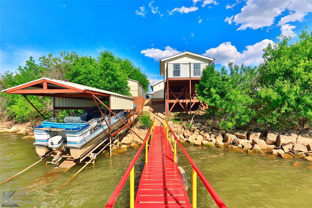 a view of a house with pool and chairs