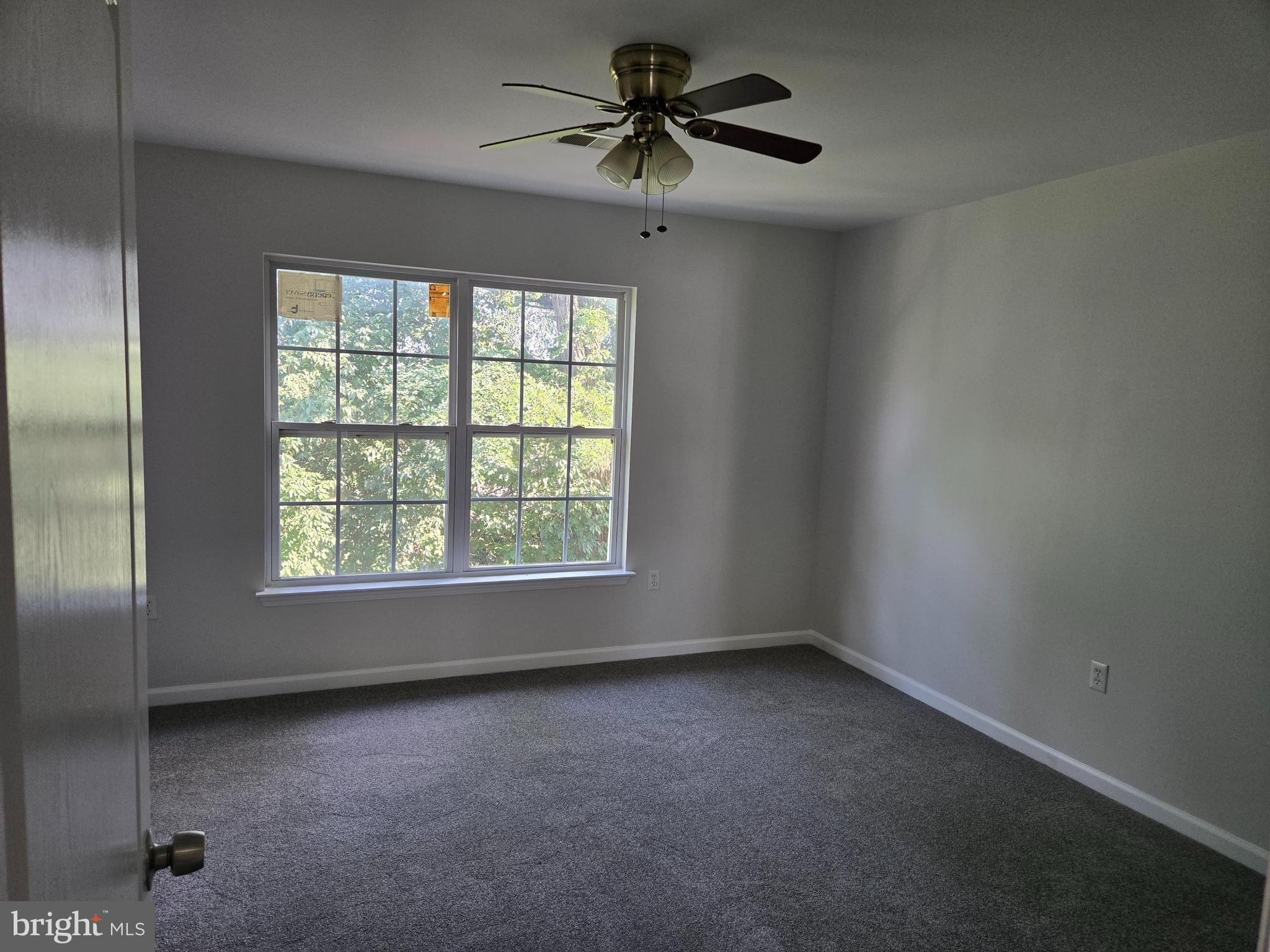 12 Russel Smith Road Lawrenceville, NJ 08648 - Photo 12 of 17 an empty room with a window and a ceiling fan