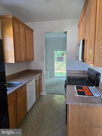a kitchen with a stove and a sink