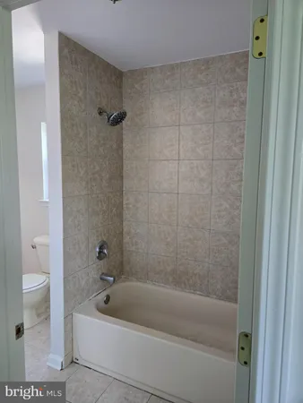 a bathroom with a bathtub and a toilet