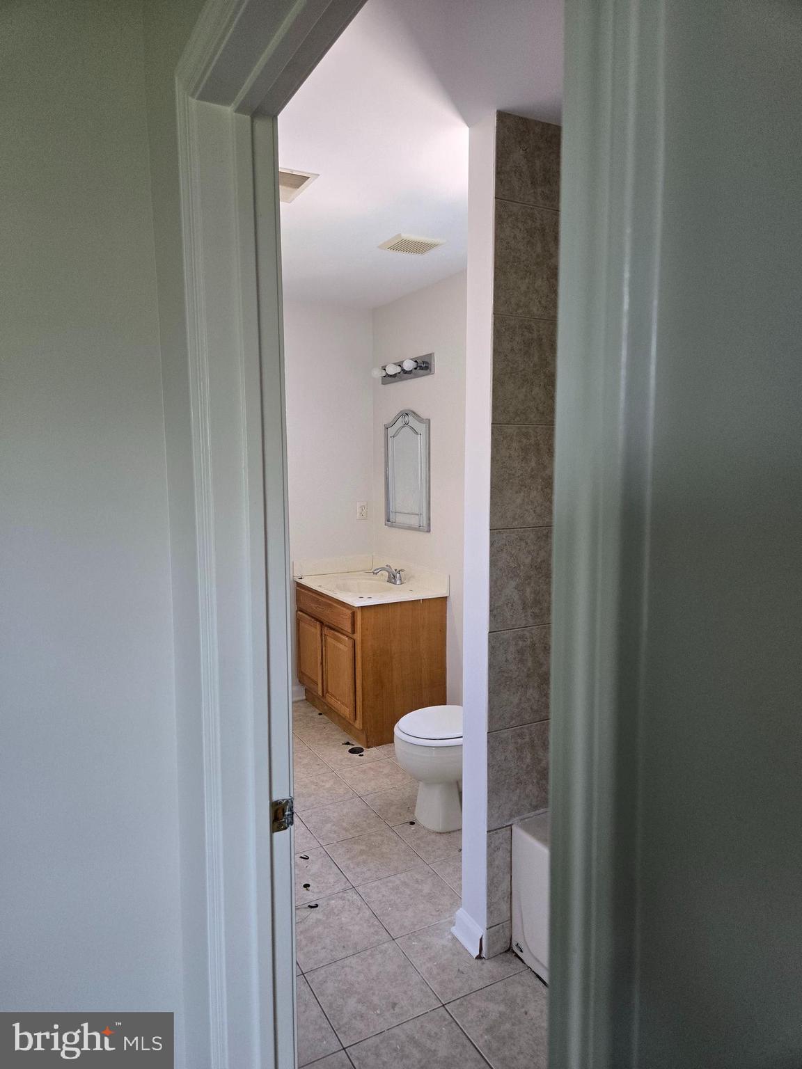 12 Russel Smith Road Lawrenceville, NJ 08648 - Photo 10 of 17 a bathroom with a toilet a sink and mirror