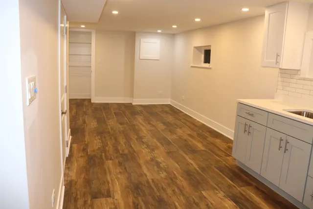 a view of hallway with wooden floor