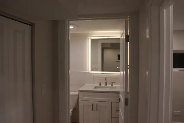 a bathroom with a sink and mirror
