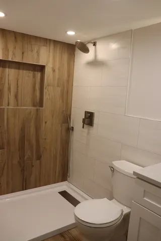 a bathroom with a toilet and a shower