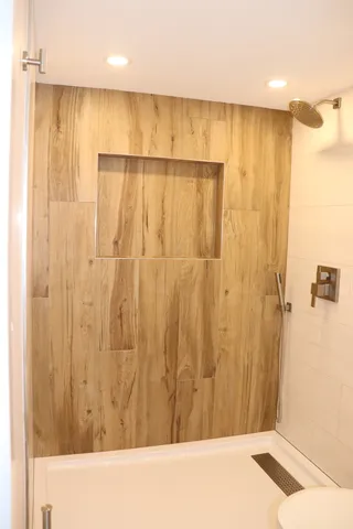 a view of a bathroom with a shower and a tub
