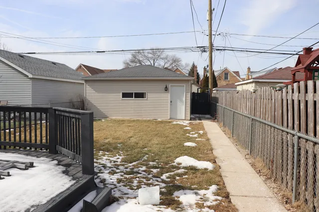 a view of a house with a wooden fence