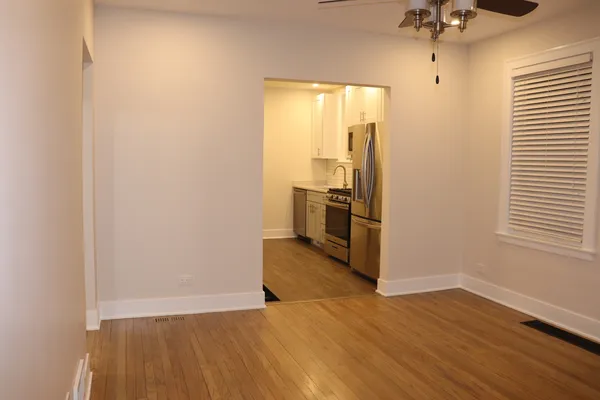 a view of a kitchen with a sink and a refrigerator
