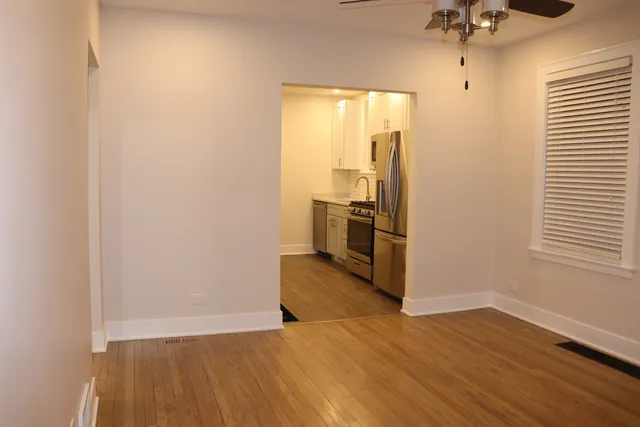 a view of a kitchen with a sink and a refrigerator