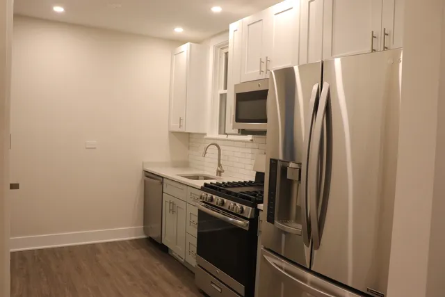 a kitchen with stainless steel appliances a refrigerator sink and stove