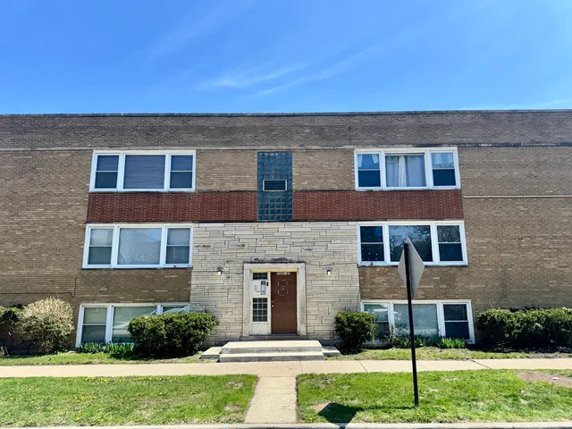 a view of a brick house with a yard