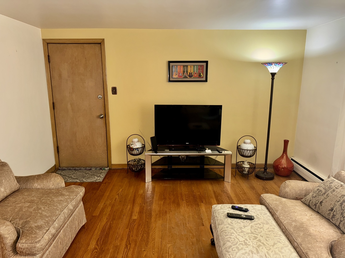 7325 South Kingston Avenue, Unit 2 Chicago, IL 60649 - Photo 4 of 13 a living room with furniture and a flat screen tv