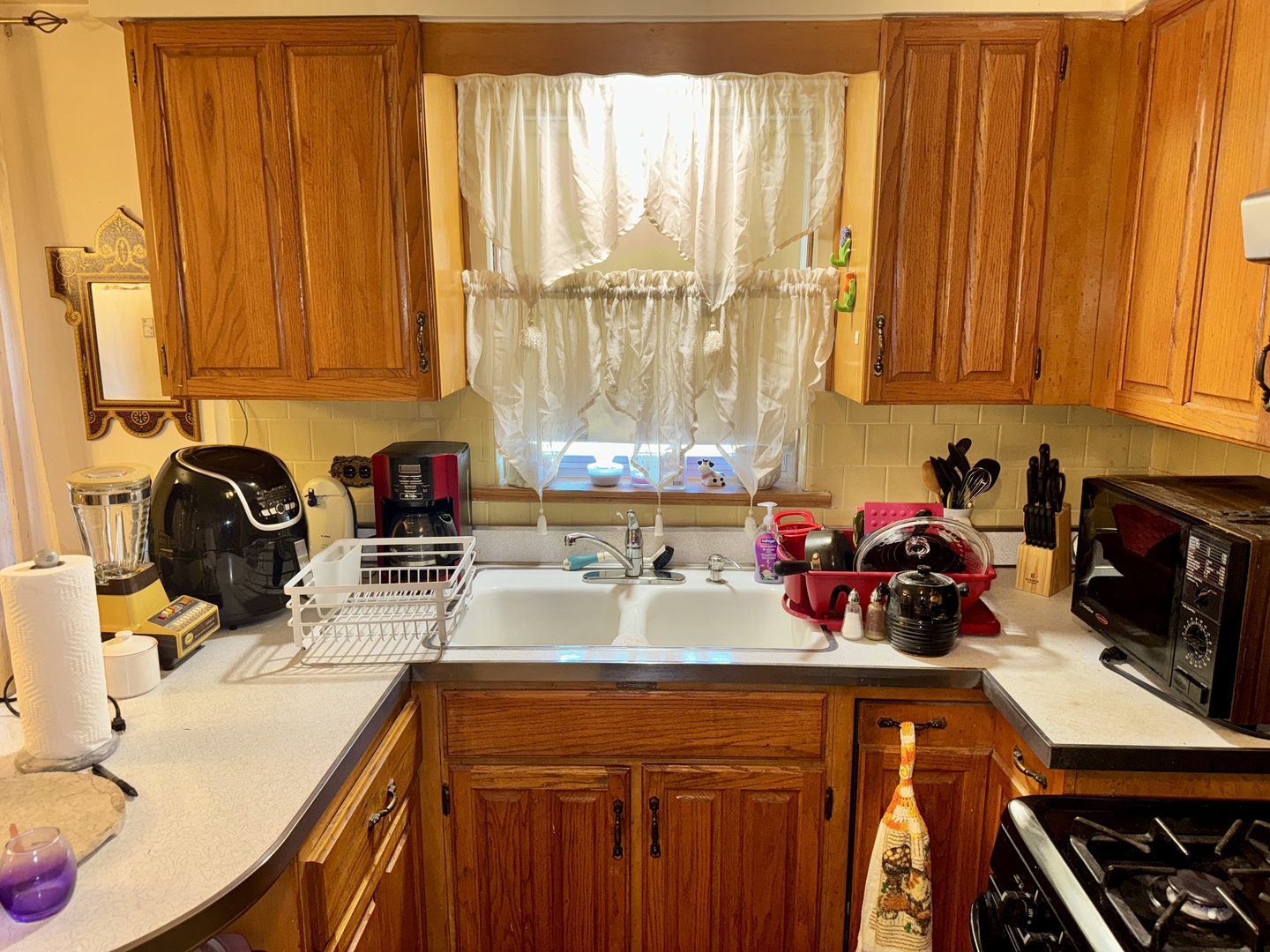 7325 South Kingston Avenue, Unit 2 Chicago, IL 60649 - Photo 6 of 13 a kitchen with a sink appliances cabinets and a large window