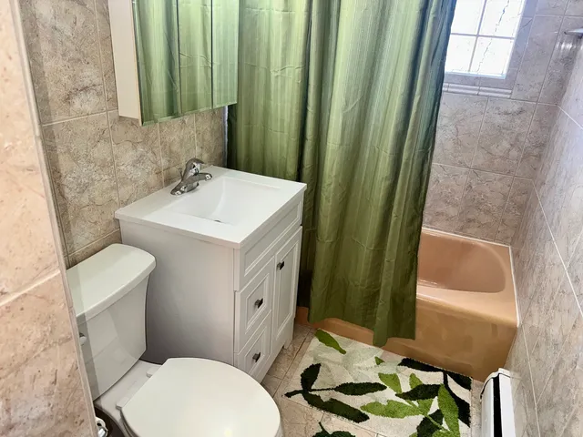 a bathroom with a toilet a sink and a mirror