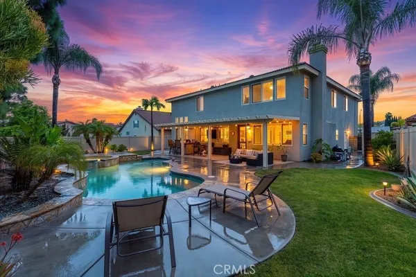 a view of a house with backyard porch and sitting area