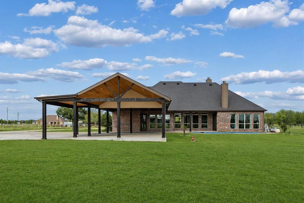 542 Pierce Road Red Oak, TX 75154 - Photo 22 of 27 Expansive covered patio featuring a vaulted wood-paneled ceiling and dark support columns