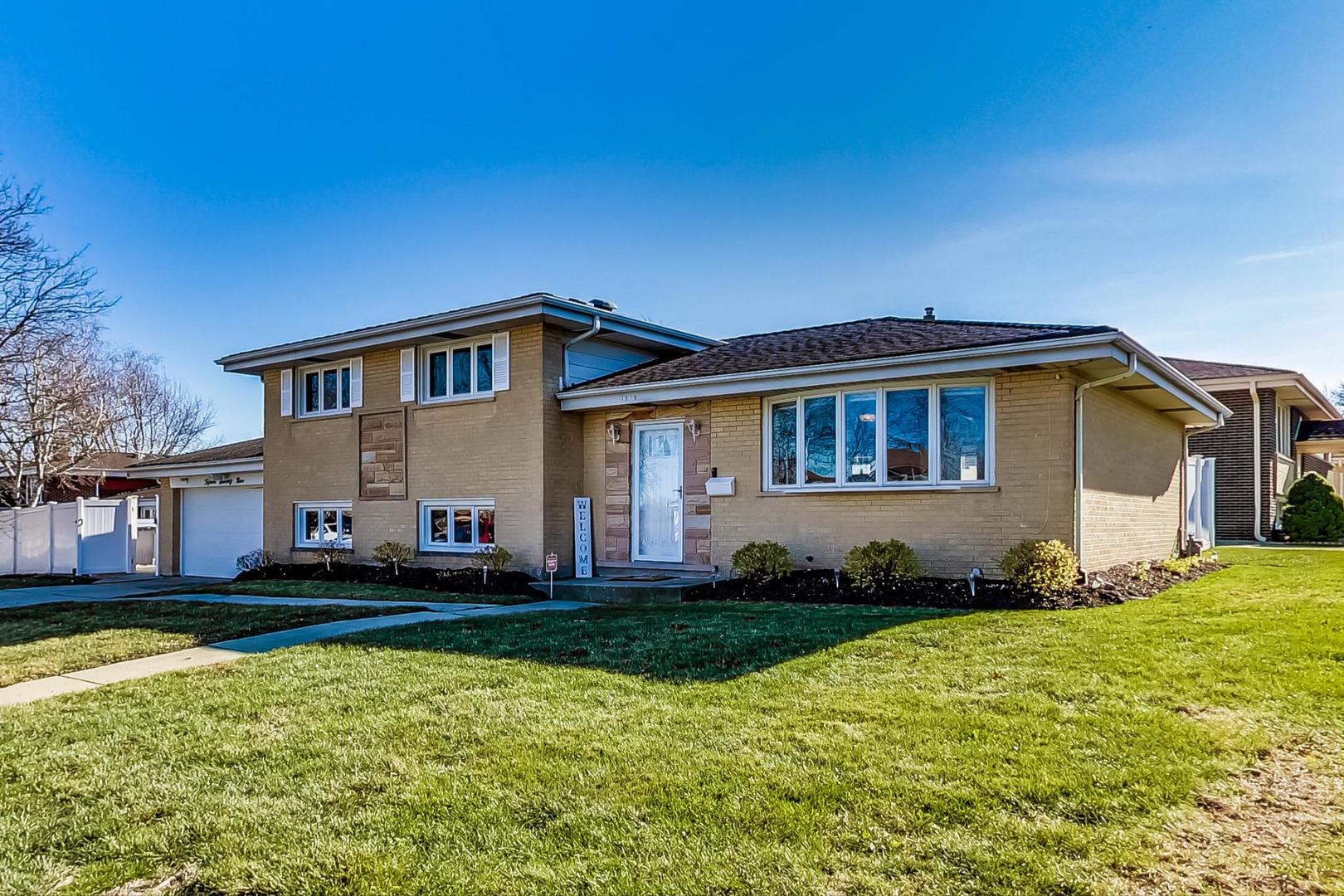 1579 West Holtz Avenue Addison, IL 60101 - Photo 1 of 43 a front view of a house with a yard