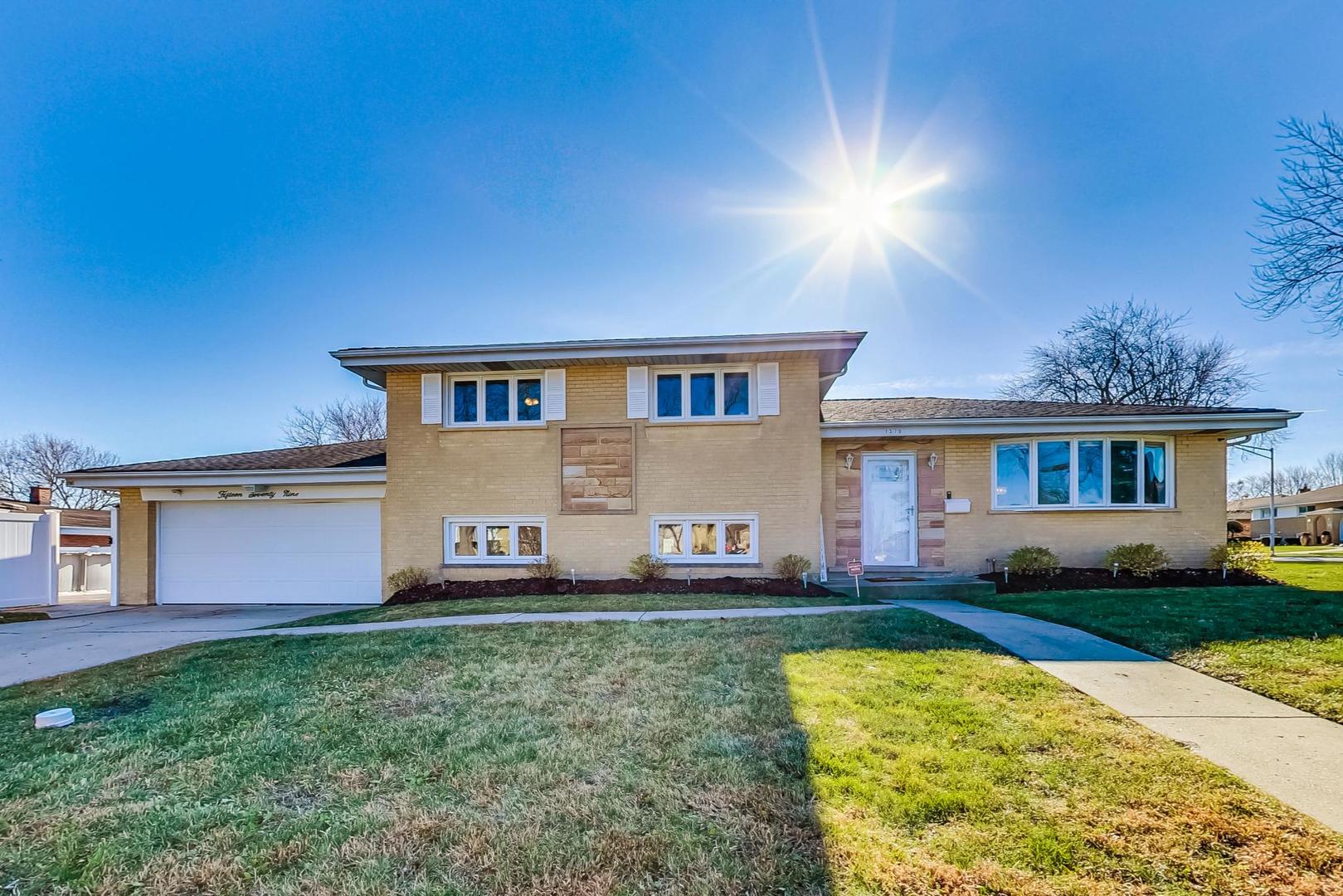 1579 West Holtz Avenue Addison, IL 60101 - Photo 2 of 43 a front view of a house with a yard