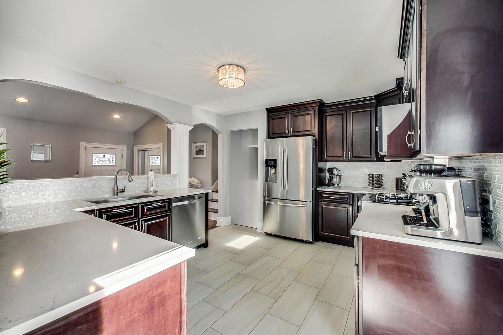 1579 West Holtz Avenue Addison, IL 60101 - Photo 13 of 43 a kitchen with a stove a refrigerator and a sink
