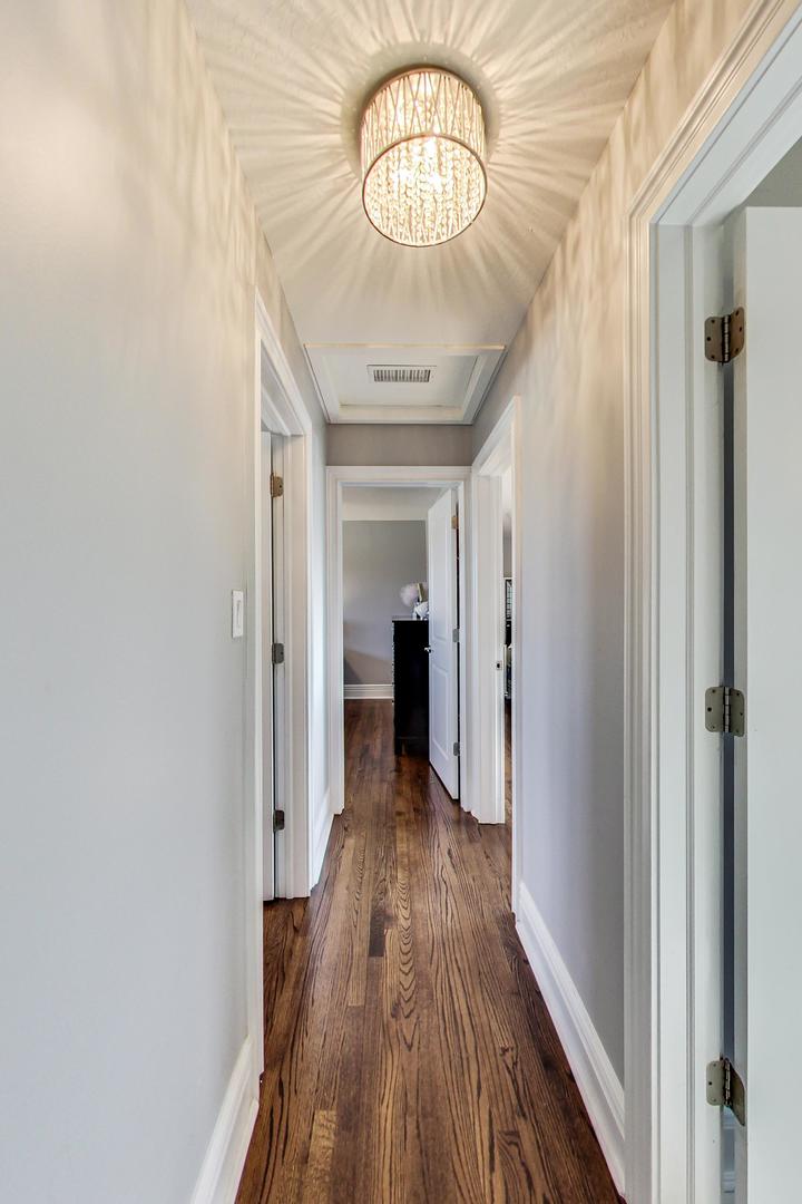 1579 West Holtz Avenue Addison, IL 60101 - Photo 15 of 43 a view of a hallway with wooden floor