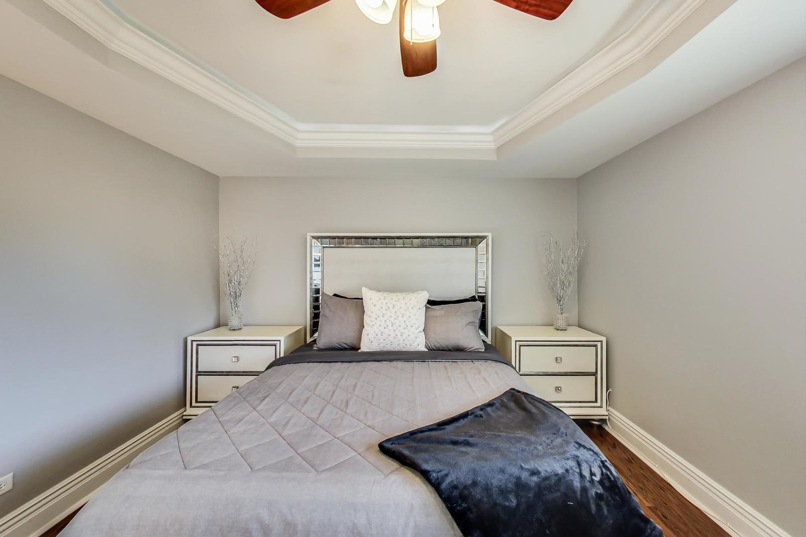 1579 West Holtz Avenue Addison, IL 60101 - Photo 17 of 43 a bedroom with a bed and lamp