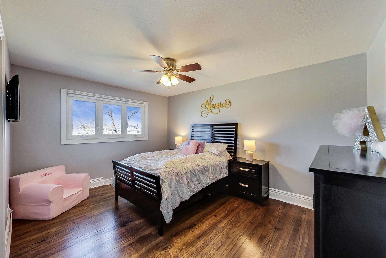 1579 West Holtz Avenue Addison, IL 60101 - Photo 21 of 43 a bedroom with a bed and a table