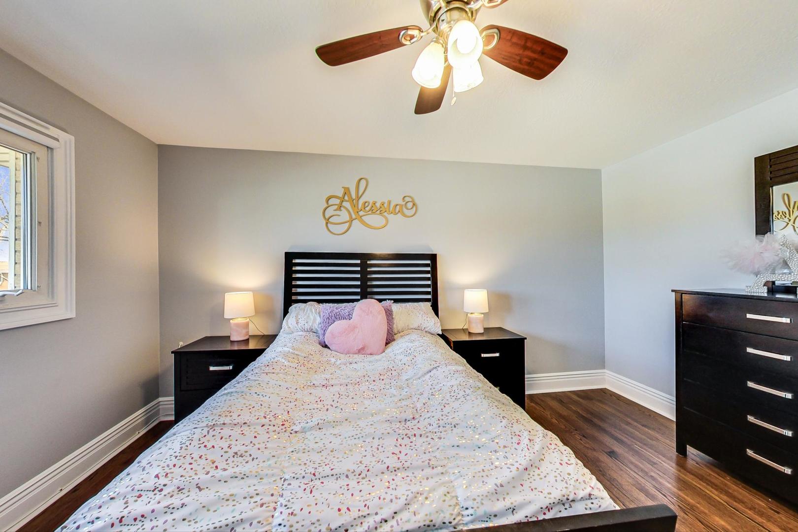 1579 West Holtz Avenue Addison, IL 60101 - Photo 23 of 43 a bedroom with a bed and wooden floor