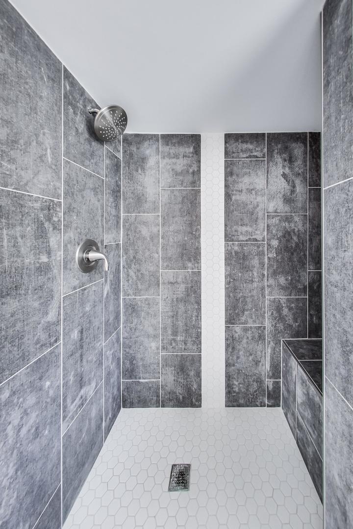 1579 West Holtz Avenue Addison, IL 60101 - Photo 31 of 43 a bathroom with a bathtub and shower