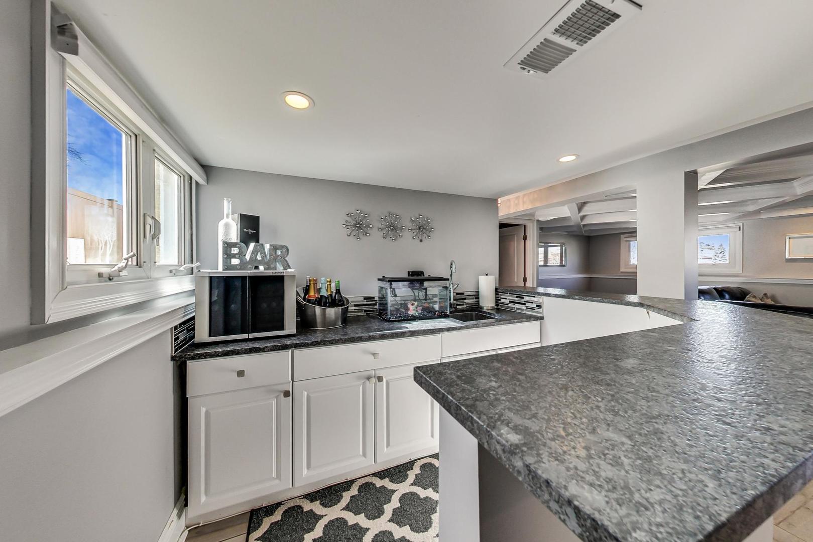 1579 West Holtz Avenue Addison, IL 60101 - Photo 33 of 43 a kitchen with granite countertop a sink and cabinets