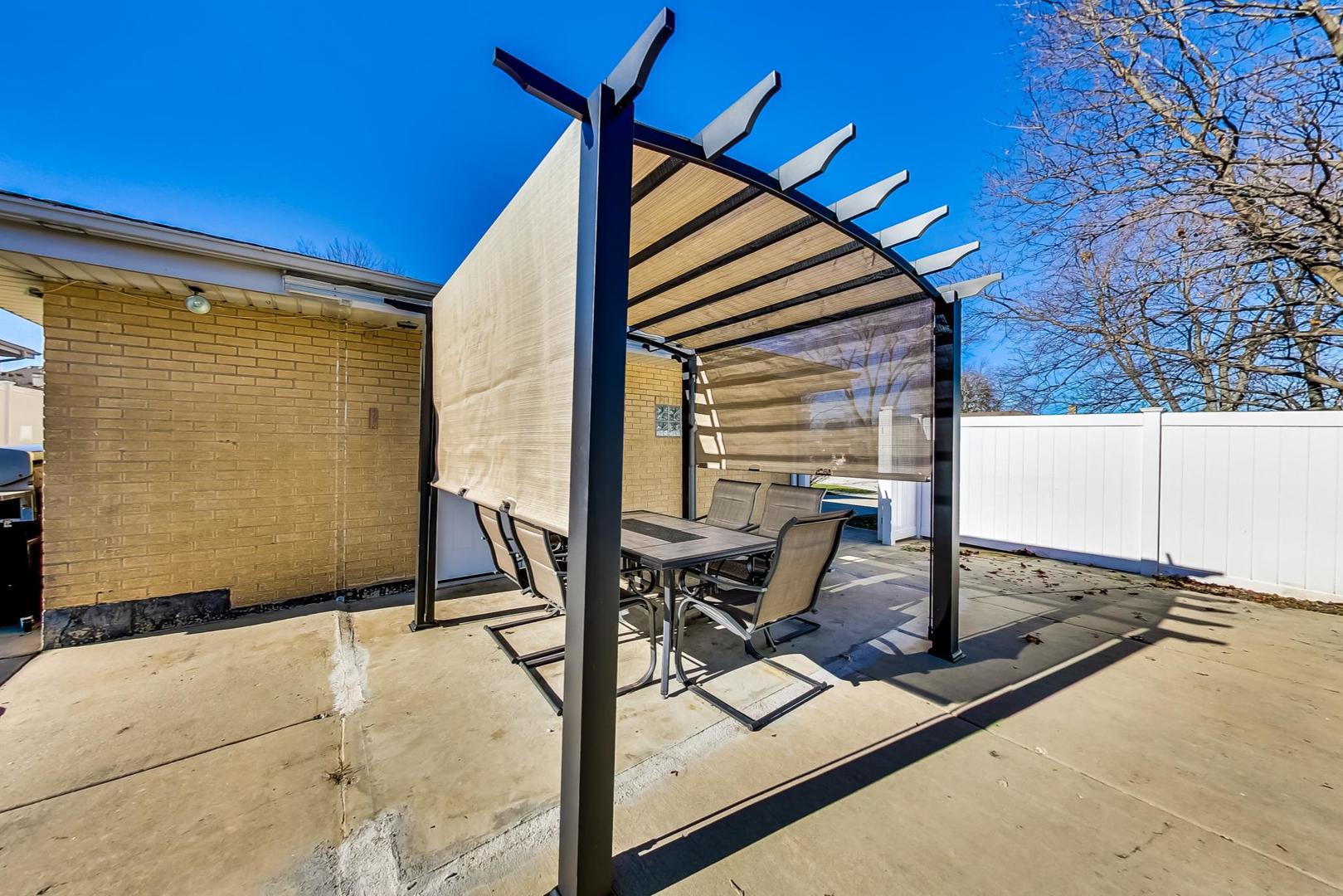 1579 West Holtz Avenue Addison, IL 60101 - Photo 37 of 43 a view of a patio with a table and chairs