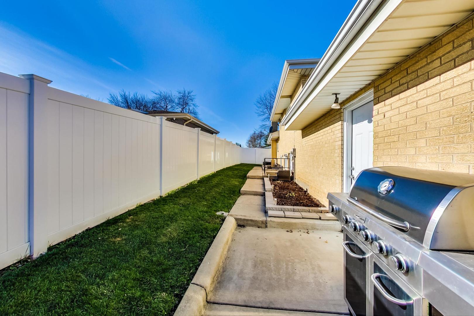 1579 West Holtz Avenue Addison, IL 60101 - Photo 39 of 43 a backyard of a house with wooden floor and fence