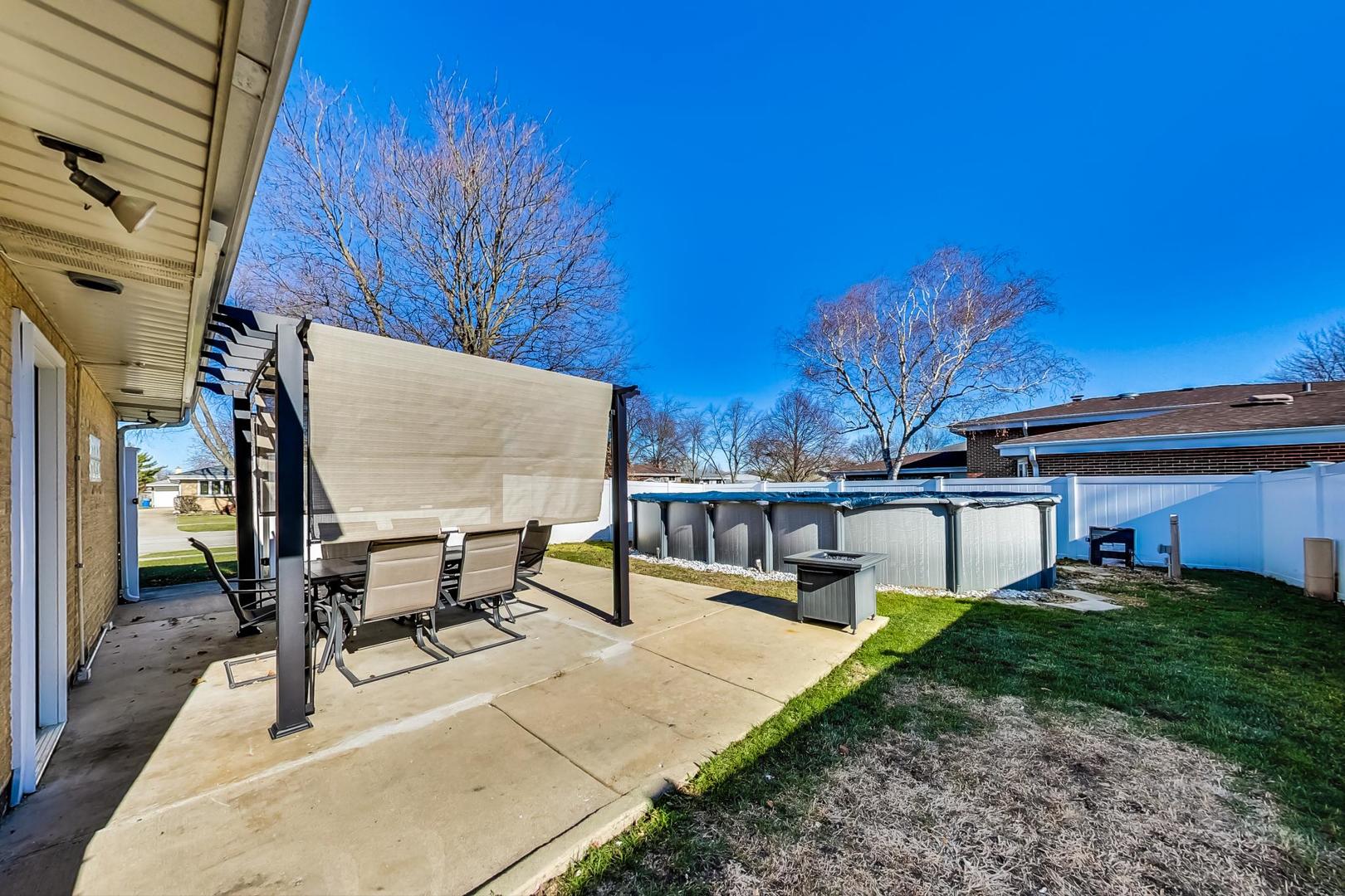 1579 West Holtz Avenue Addison, IL 60101 - Photo 40 of 43 a view of a patio with table and chairs with wooden floor and fence