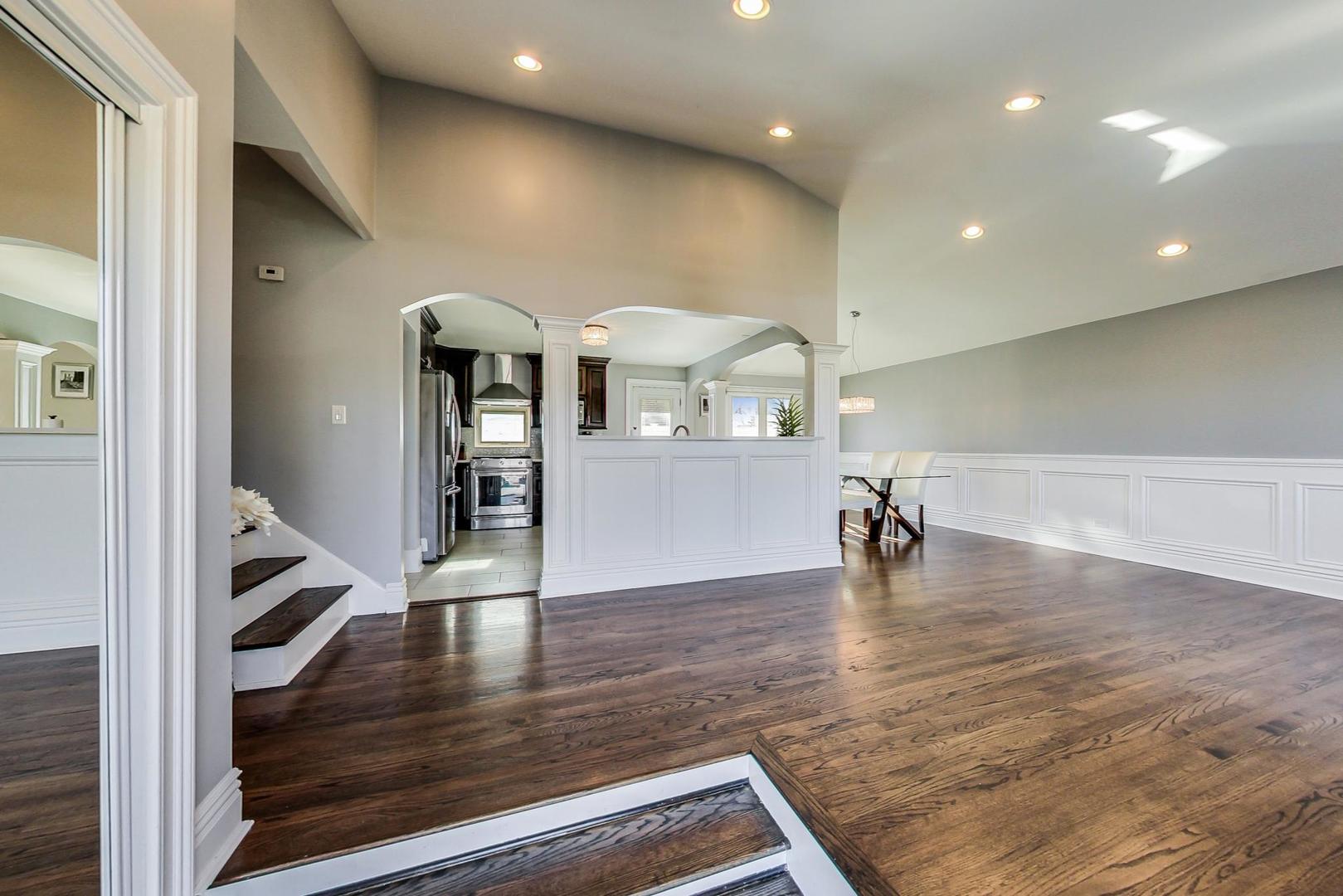 1579 West Holtz Avenue Addison, IL 60101 - Photo 6 of 43 a view of a living room and dining room with wooden floor