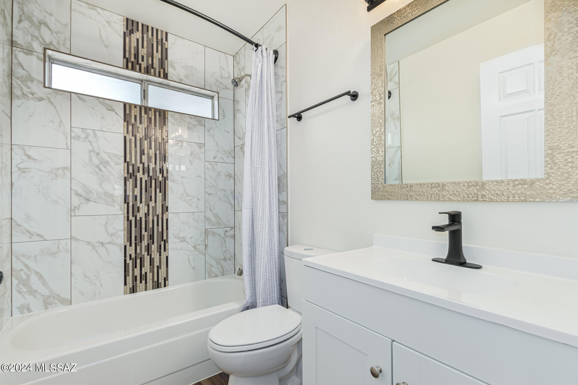 1454 South Gecko Road Tucson, AZ 85713 - Photo 21 of 24 a bathroom with a sink toilet and shower