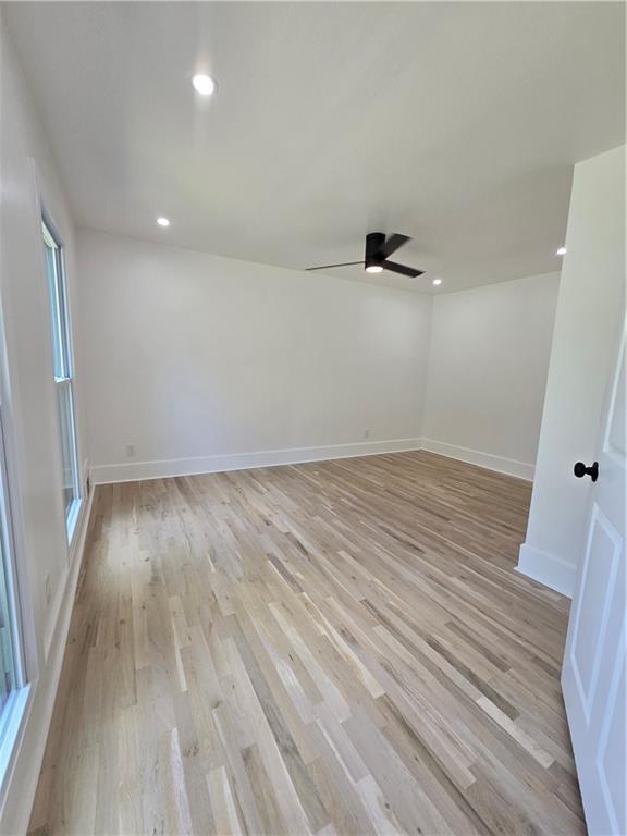 3832 Finger Creek Southwest Lilburn, GA 30047 - Photo 16 of 24 an empty room with wooden floor and windows