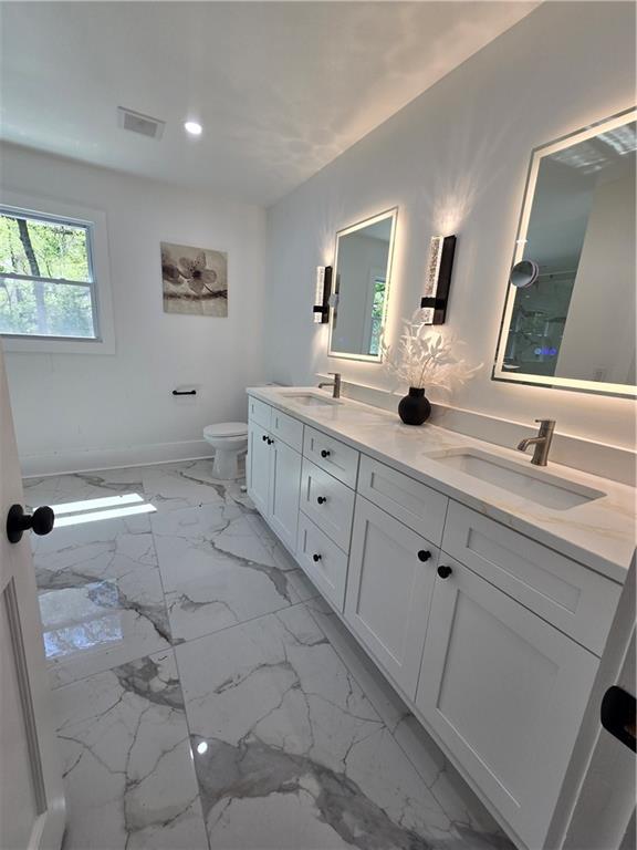 3832 Finger Creek Southwest Lilburn, GA 30047 - Photo 17 of 24 a spacious bathroom with a double vanity sink and a mirror