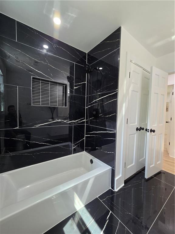 3832 Finger Creek Southwest Lilburn, GA 30047 - Photo 20 of 24 a bathroom with a bathtub and a shower