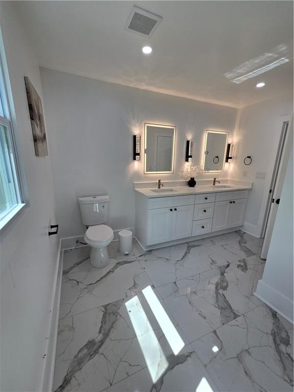 3832 Finger Creek Southwest Lilburn, GA 30047 - Photo 23 of 24 a spacious bathroom with a sink a toilet and a mirror