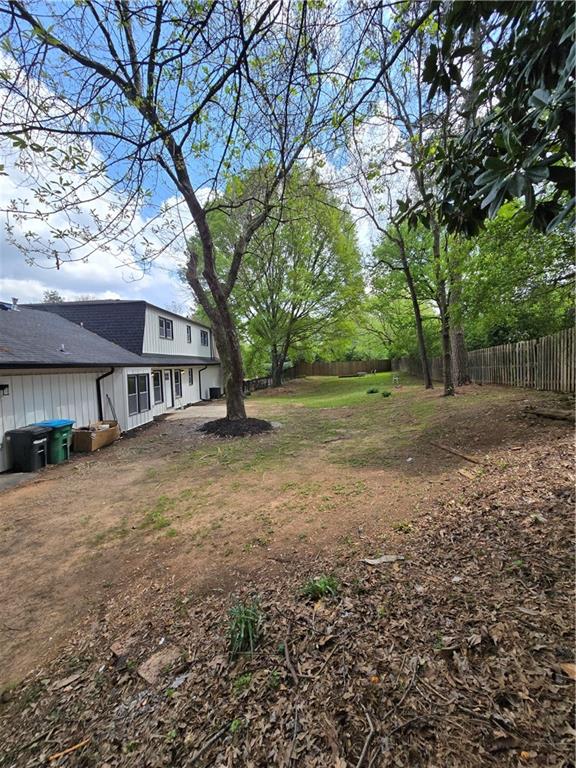 3832 Finger Creek Southwest Lilburn, GA 30047 - Photo 24 of 24 a view of a yard with a house and a large tree