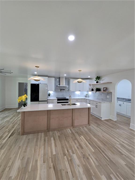 3832 Finger Creek Southwest Lilburn, GA 30047 - Photo 9 of 24 a large kitchen with kitchen island a sink white cabinets and stainless steel appliances