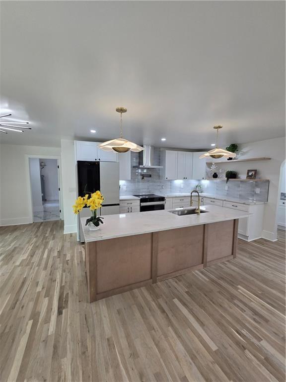 3832 Finger Creek Southwest Lilburn, GA 30047 - Photo 10 of 24 a large kitchen with kitchen island a stove a sink dishwasher and a dining table with wooden floor