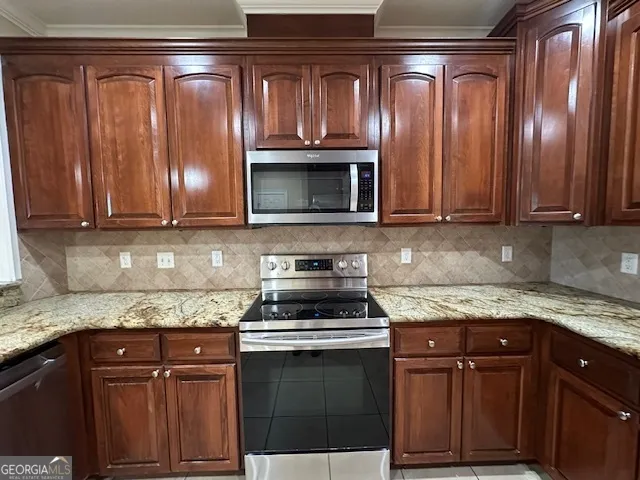 a view of an empty room with a window and a kitchen