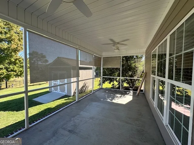 a view of a backyard with plants and patio