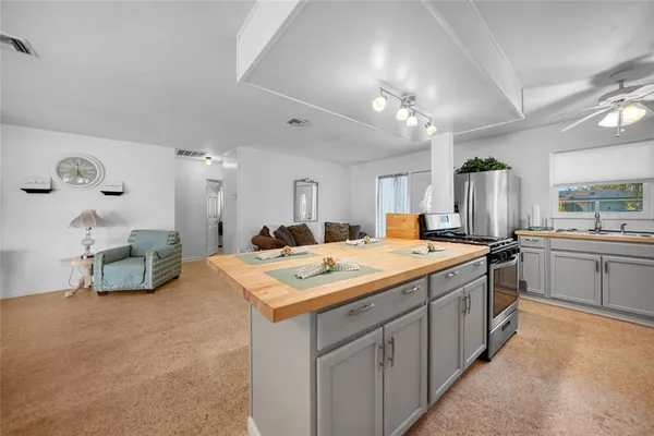 a large kitchen with a sink and cabinets