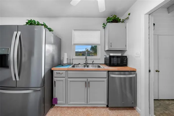 a kitchen with stainless steel appliances a refrigerator and a sink