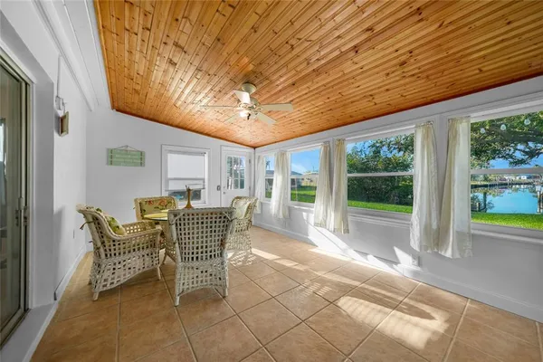 a dining room with furniture and large windows