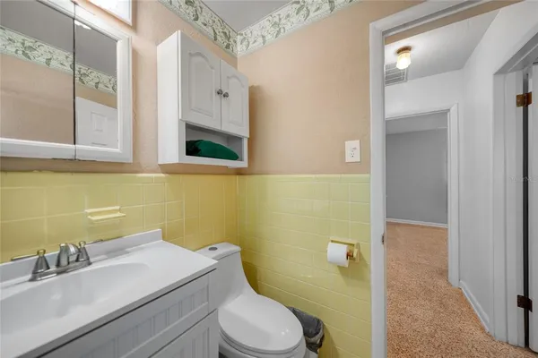 a bathroom with a sink toilet and mirror