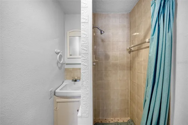 a bathroom with a shower a toilet and a sink